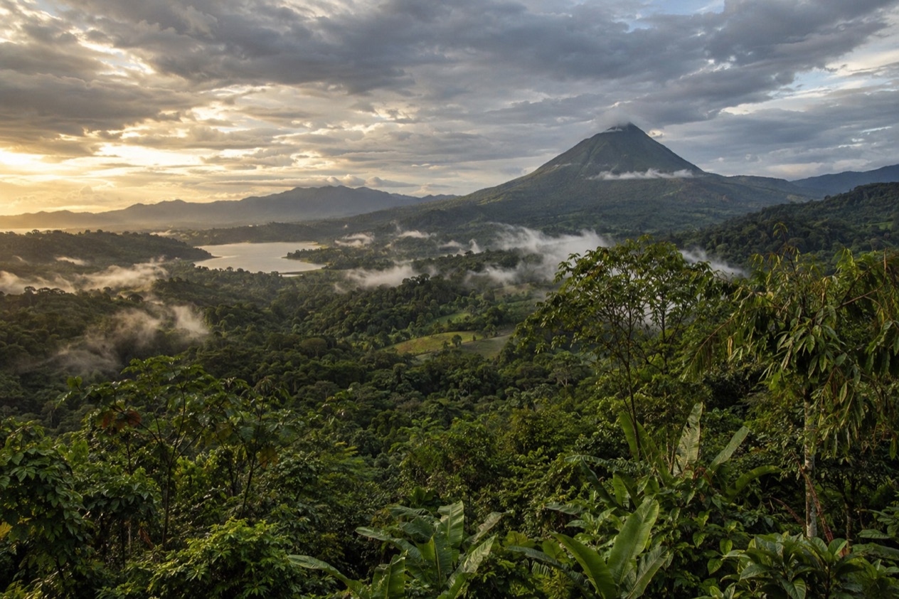 Green hills and a volcano in Costa Rica in the rainiest months