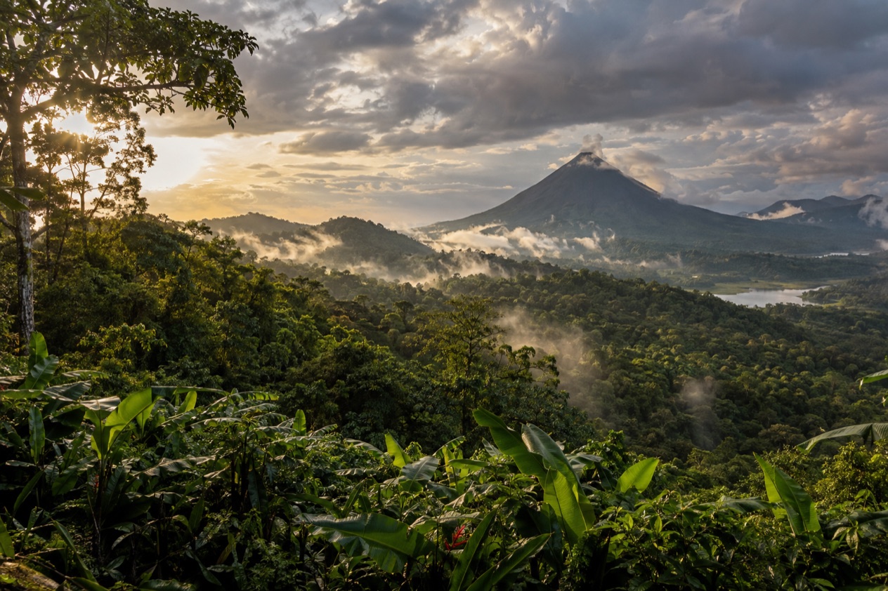 Green hills and a volcano in Costa Rica in the rainiest months