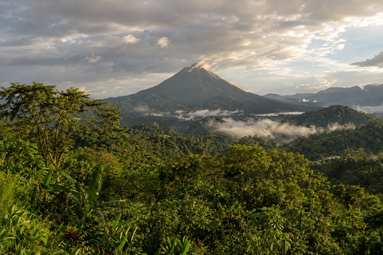 Green hills and a volcano in Costa Rica in the rainiest months