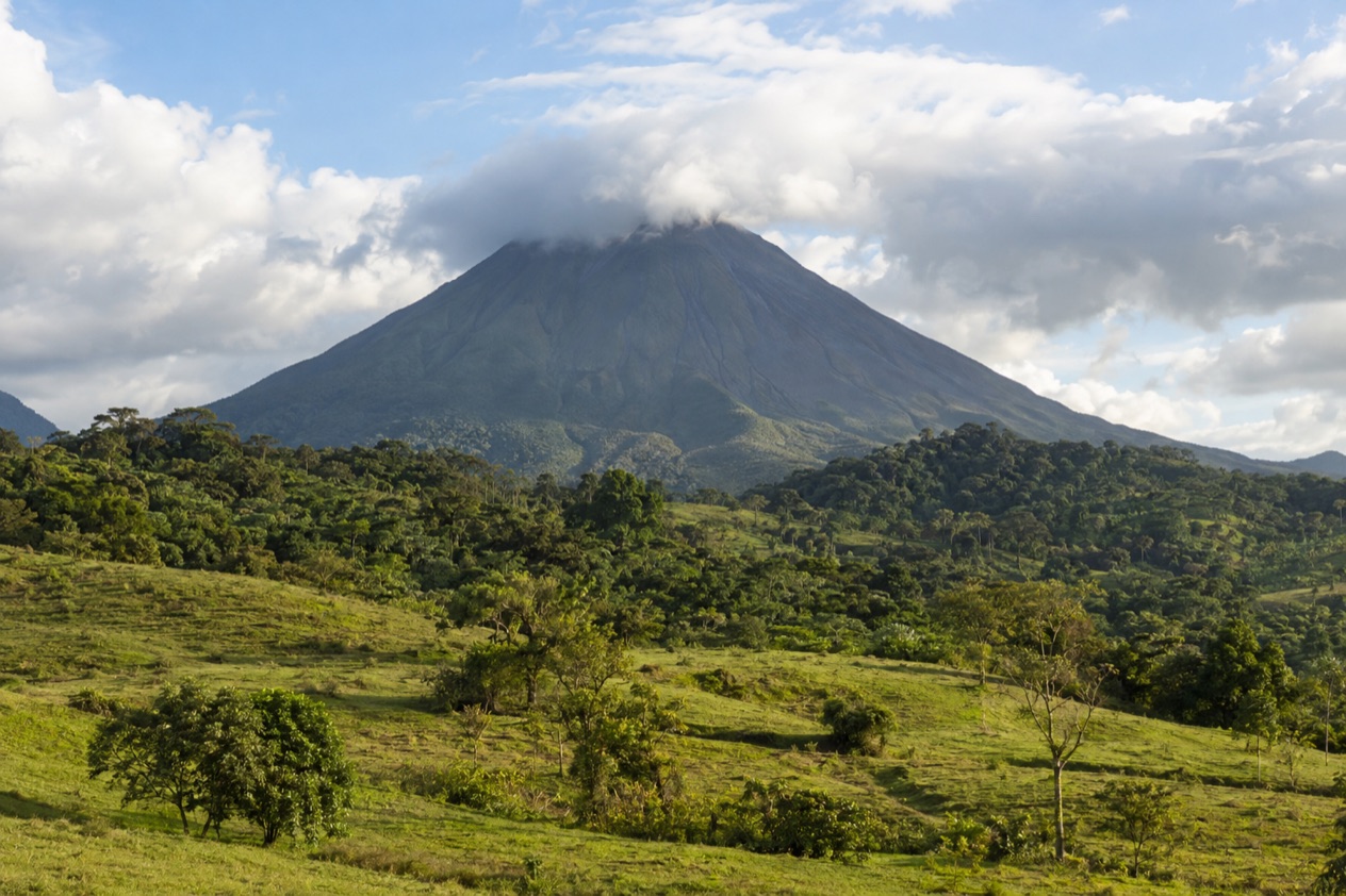 Arenal Volcano above the fields near La Fortuna