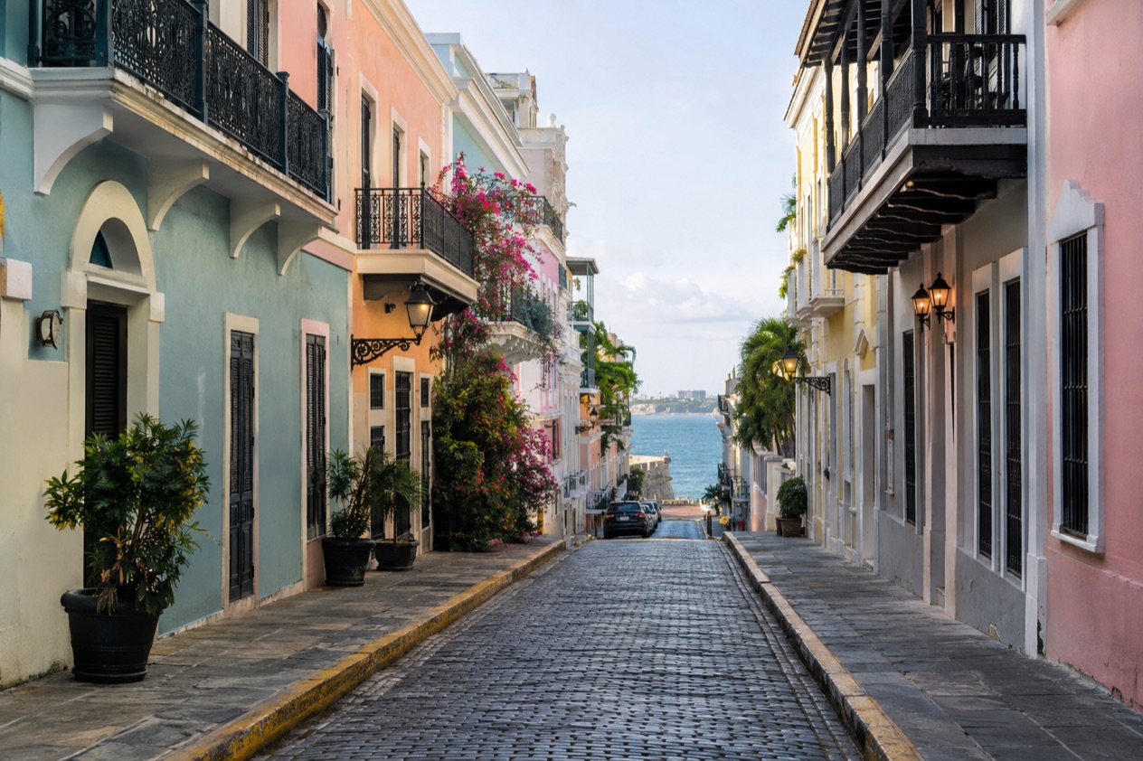 A cobblestone street in Old San Juan between pastel colonial houses