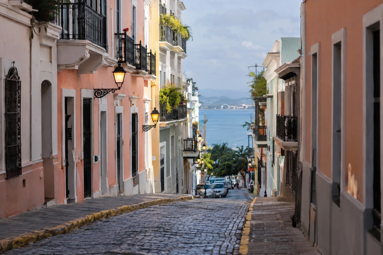 A cobblestone street in Old San Juan between pastel colonial houses